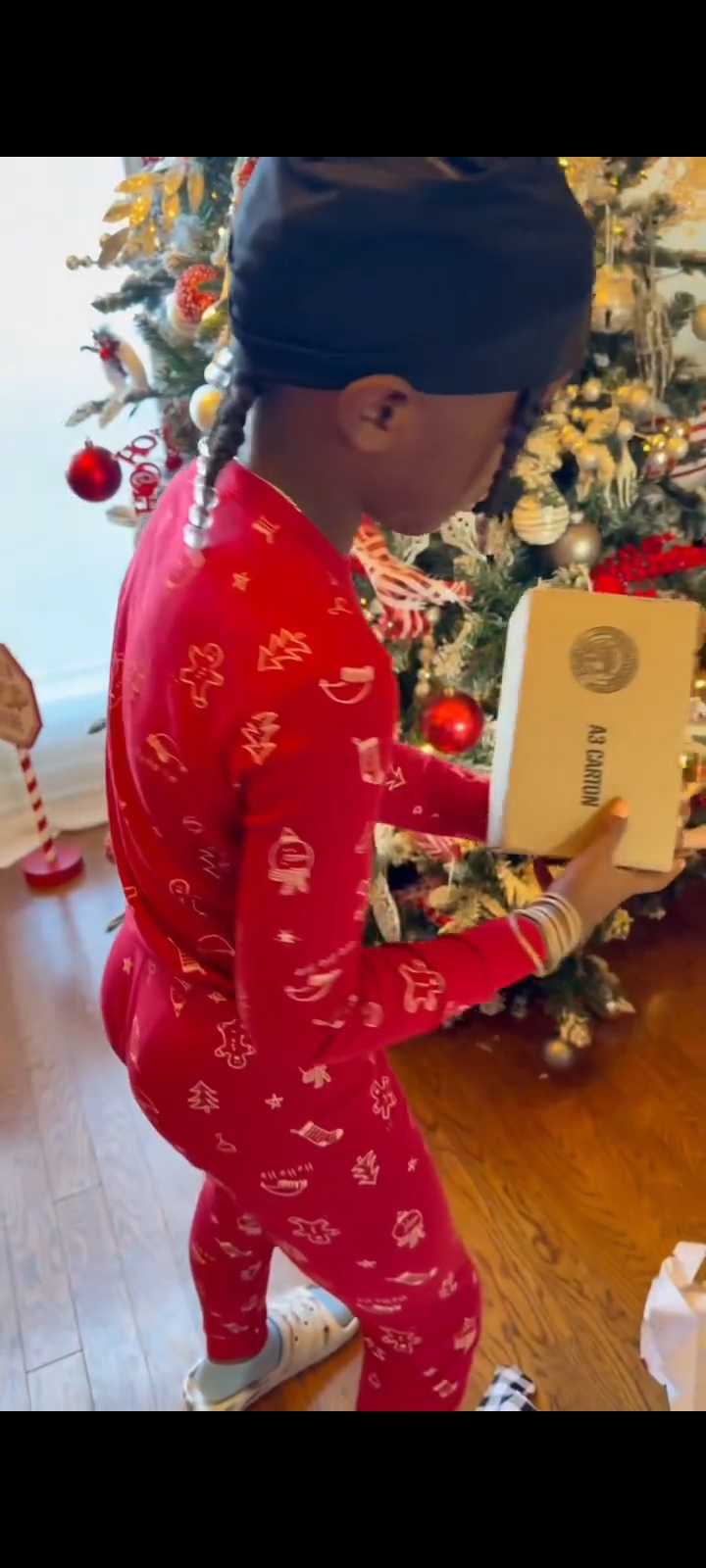 Black boy opening Christmas gift